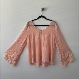 Women’s blush blouse, sheer with lace detailing on bell sleeves